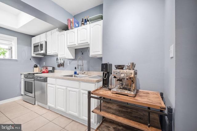 864 Moyer St, Philadelphia, PA 19125 - kitchen featuring appliances with stainless steel finishes, light countertops, white cabinetry, and light tile patterned flooring
