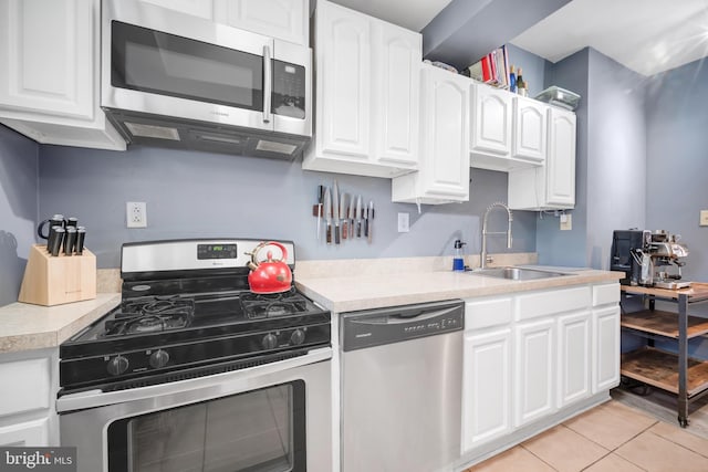 864 Moyer St, Philadelphia, PA 19125 - kitchen featuring appliances with stainless steel finishes, white cabinets, light countertops, and light tile patterned floors