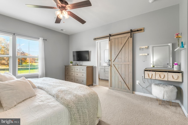 932 Dawes Ct, Bel Air, MD 21014 - bedroom with a barn door, light colored carpet, ensuite bathroom, and ceiling fan