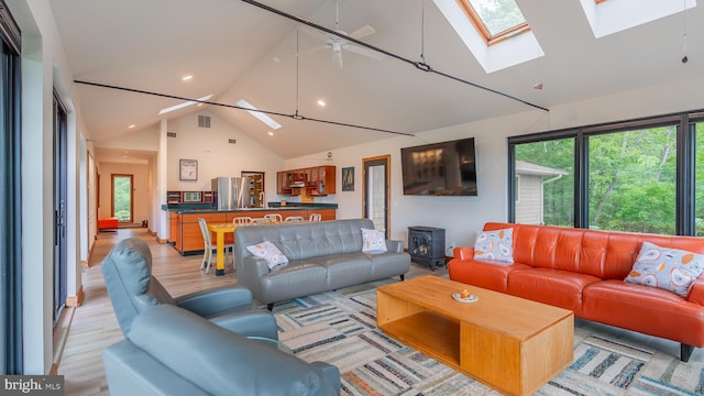 302 Fox Run Rd, Wardensville, WV 26851 - living room with a skylight, a wood stove, high vaulted ceiling, light wood-type flooring, and recessed lighting