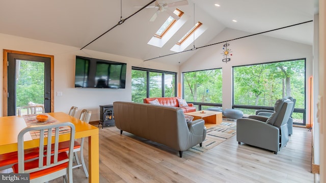 302 Fox Run Rd, Wardensville, WV 26851 - living area featuring a skylight, a wood stove, high vaulted ceiling, light wood-style floors, and recessed lighting