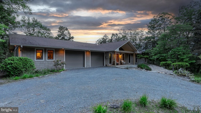 302 Fox Run Rd, Wardensville, WV 26851 - view of front of property featuring an attached garage, covered porch, gravel driveway, and a shingled roof
