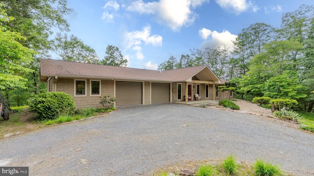 302 Fox Run Rd, Wardensville, WV 26851 - single story home with an attached garage, driveway, a porch, and roof with shingles