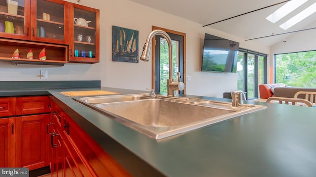 302 Fox Run Rd, Wardensville, WV 26851 - kitchen featuring a skylight, glass insert cabinets, lofted ceiling, and reddish brown cabinets