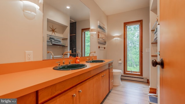 302 Fox Run Rd, Wardensville, WV 26851 - bathroom with baseboard heating, vanity, wood-type flooring, and recessed lighting