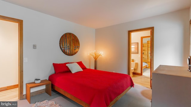 302 Fox Run Rd, Wardensville, WV 26851 - bedroom featuring wood finished floors and ensuite bathroom