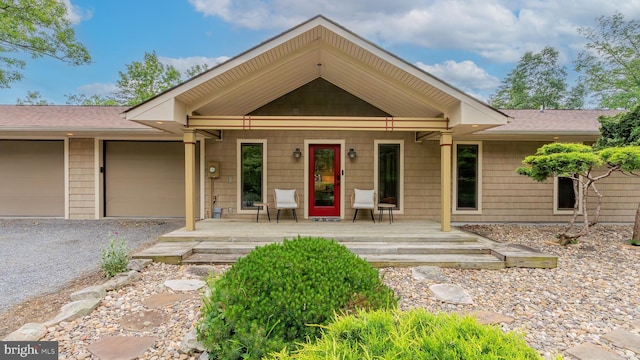 302 Fox Run Rd, Wardensville, WV 26851 - view of front of home featuring covered porch, gravel driveway, an attached garage, and a shingled roof