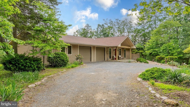 302 Fox Run Rd, Wardensville, WV 26851 - single story home with dirt driveway, an attached garage, roof with shingles, and a porch