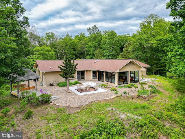 302 Fox Run Rd, Wardensville, WV 26851 - back of house with a sunroom, a patio area, a gazebo, a view of trees, and a shingled roof