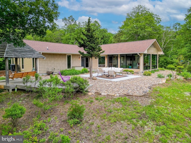 302 Fox Run Rd, Wardensville, WV 26851 - back of property with a deck, a patio, a sunroom, and roof with shingles