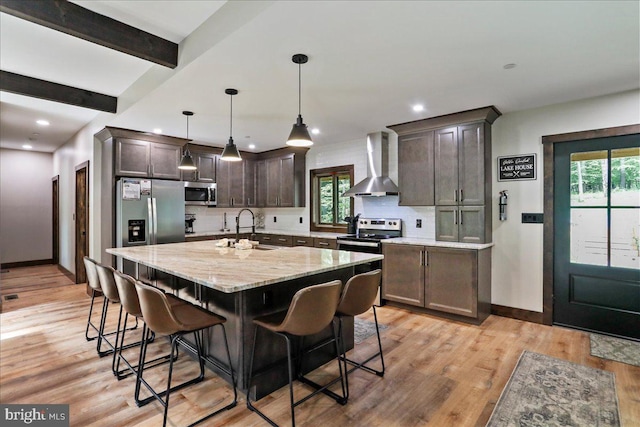 130 Lodestone Way, Mc Henry, MD 21541 - kitchen with appliances with stainless steel finishes, wall chimney exhaust hood, a breakfast bar area, backsplash, and recessed lighting