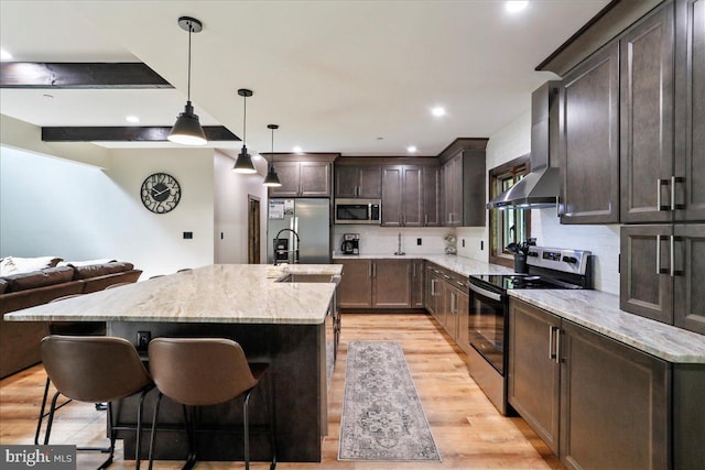 130 Lodestone Way, Mc Henry, MD 21541 - kitchen featuring appliances with stainless steel finishes, light wood-style floors, dark brown cabinets, open floor plan, and decorative backsplash