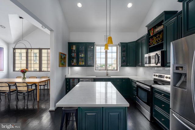 1823 Belmont Rd NW Unit D, Washington, DC 20009 - kitchen with stainless steel appliances, lofted ceiling, dark wood-style floors, a kitchen island, and hanging light fixtures