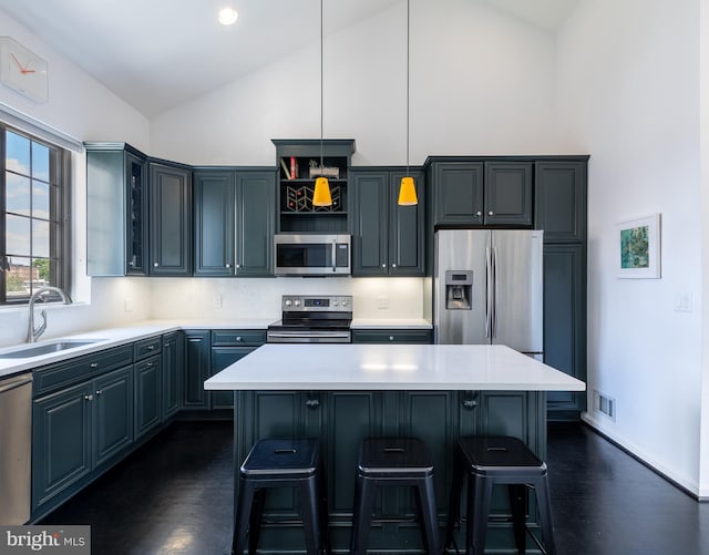 1823 Belmont Rd NW Unit D, Washington, DC 20009 - kitchen featuring stainless steel appliances, high vaulted ceiling, a kitchen breakfast bar, light countertops, and pendant lighting