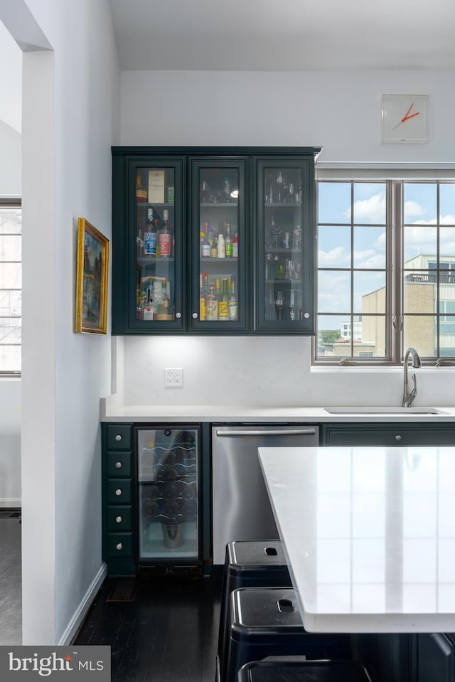 1823 Belmont Rd NW Unit D, Washington, DC 20009 - indoor dry bar featuring beverage cooler, stainless steel dishwasher, dark wood-type flooring, and plenty of natural light