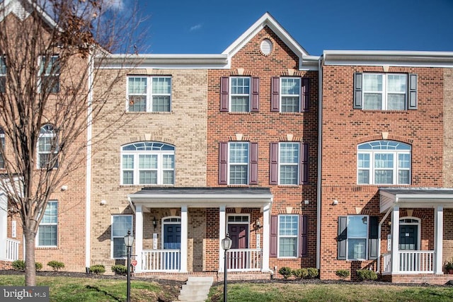 1734 Featherstone Rd, Woodbridge, VA 22191 - view of property featuring brick siding and a porch