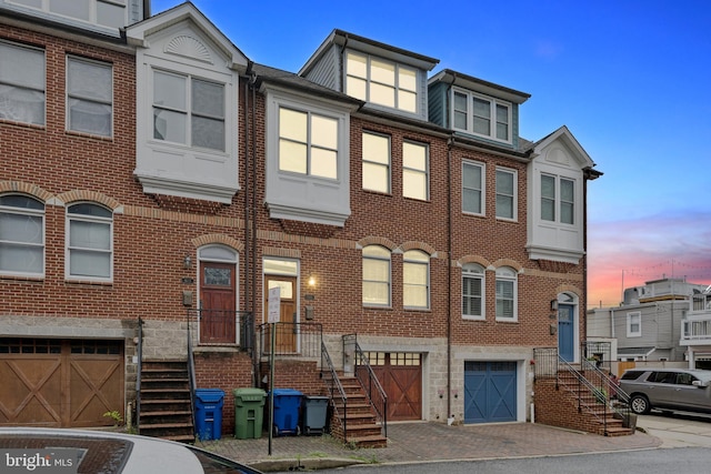 1013 S Decker Ave, Baltimore, MD 21224 - view of property with an attached garage, brick siding, and driveway