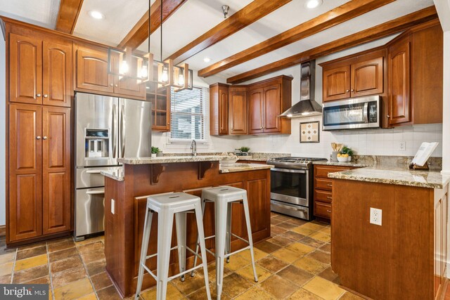 1013 S Decker Ave, Baltimore, MD 21224 - kitchen featuring stainless steel appliances, wall chimney range hood, a kitchen bar, stone tile flooring, and beamed ceiling