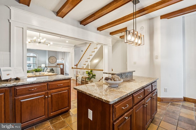1013 S Decker Ave, Baltimore, MD 21224 - kitchen featuring a chandelier, beam ceiling, light stone counters, open floor plan, and pendant lighting