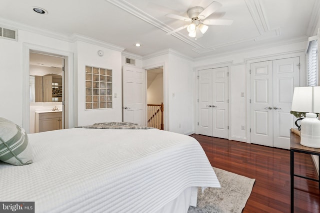 1013 S Decker Ave, Baltimore, MD 21224 - bedroom with dark wood finished floors, two closets, attic access, crown molding, and recessed lighting