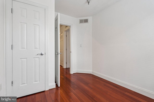 1013 S Decker Ave, Baltimore, MD 21224 - unfurnished bedroom featuring baseboards and dark wood-style floors