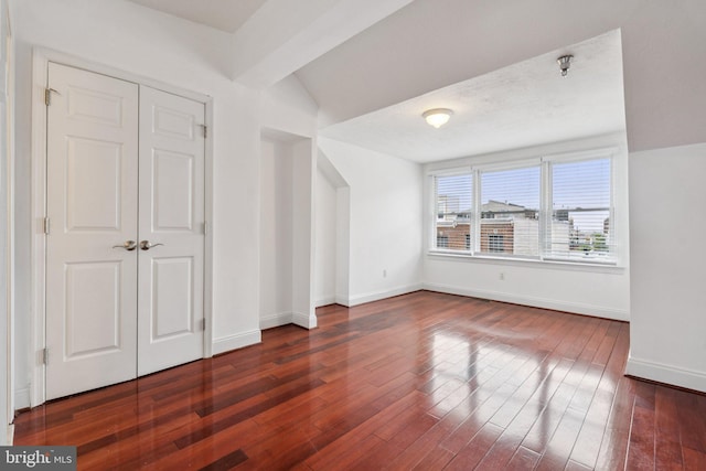 1013 S Decker Ave, Baltimore, MD 21224 - unfurnished bedroom with dark wood-style flooring and lofted ceiling