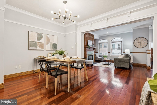 1013 S Decker Ave, Baltimore, MD 21224 - dining area with a glass covered fireplace, a chandelier, ornamental molding, and dark wood finished floors