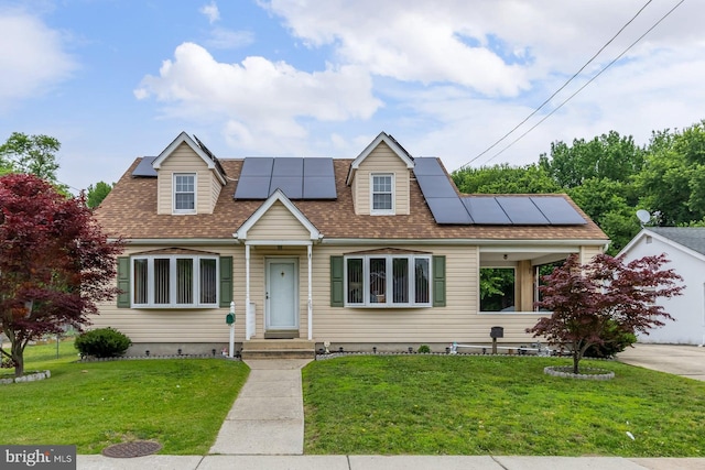207 E Main St, Penns Grove, NJ 08069 - new england style home with roof mounted solar panels, a front yard, and roof with shingles
