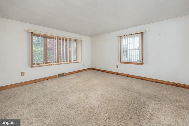 207 E Main St, Penns Grove, NJ 08069 - unfurnished room featuring healthy amount of natural light and carpet floors