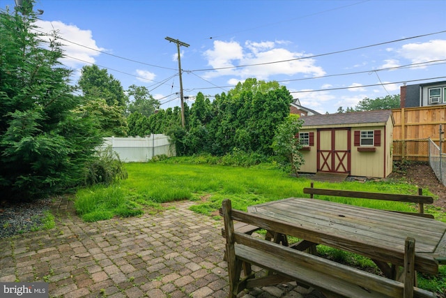 204 Opal Ave, Reading, PA 19606 - fenced backyard with a storage unit and a patio area