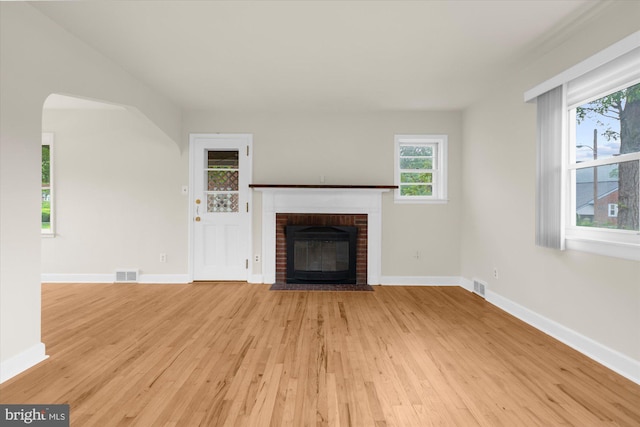 204 Opal Ave, Reading, PA 19606 - unfurnished living room featuring light wood-style flooring and a brick fireplace