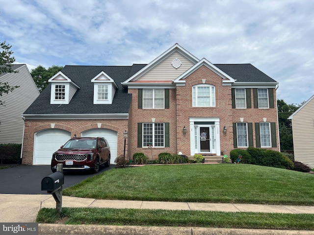 13508 Wembley Loop, Bristow, VA 20136 - colonial inspired home with brick siding, a front yard, driveway, and roof with shingles