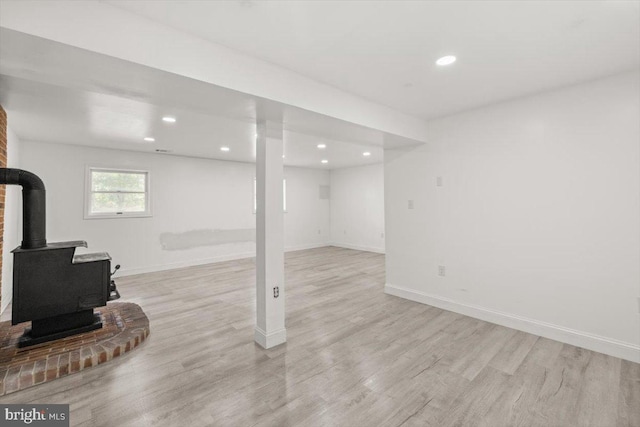 95 Arthur Burke Ln, Front Royal, VA 22630 - basement with light wood-type flooring, a wood stove, and recessed lighting