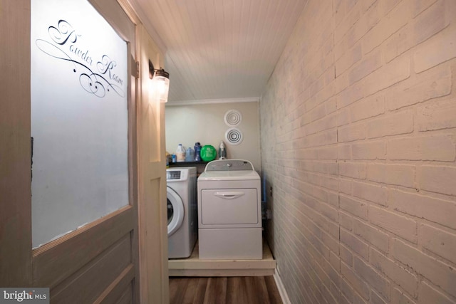 134 Catlett Mountain Rd, Front Royal, VA 22630 - laundry room featuring washing machine and dryer, dark wood finished floors, ornamental molding, and brick wall