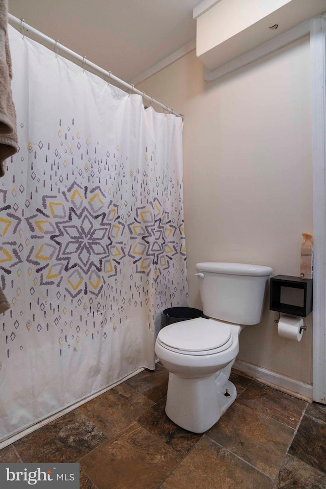 134 Catlett Mountain Rd, Front Royal, VA 22630 - bathroom with stone tile floors, curtained shower, and ornamental molding