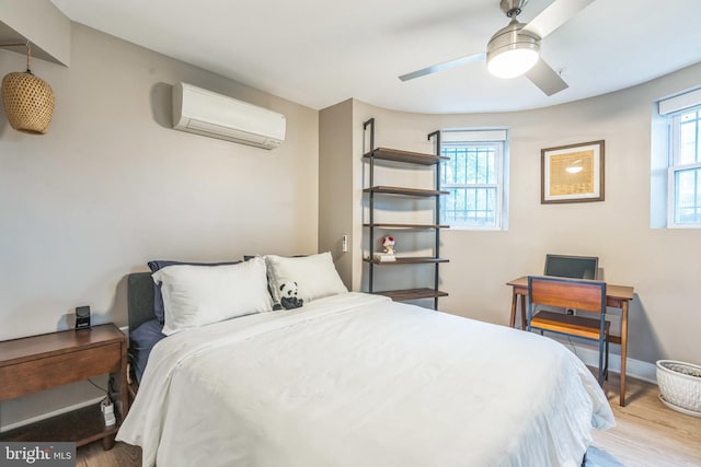 459 Massachusetts Ave NW Unit B1, Washington, DC 20001 - bedroom featuring a wall unit AC, wood finished floors, and ceiling fan