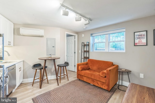 459 Massachusetts Ave NW Unit B1, Washington, DC 20001 - living area featuring a wall mounted AC, electric panel, track lighting, and light wood finished floors