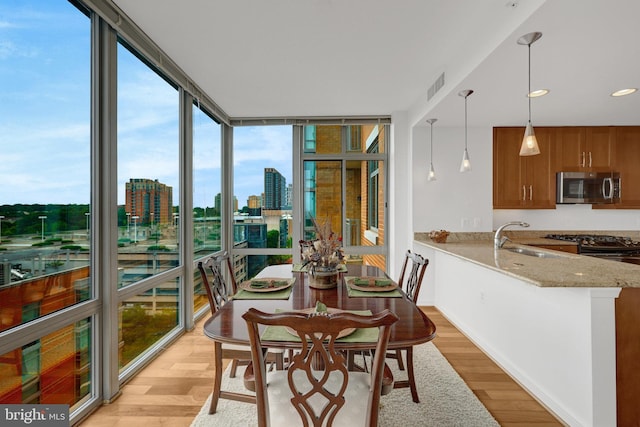 11990 Market St Unit 907, Reston, VA 20190 - dining area with floor to ceiling windows, light wood-style floors, a view of city, and recessed lighting