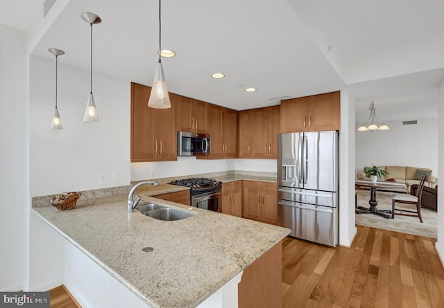11990 Market St Unit 907, Reston, VA 20190 - kitchen featuring stainless steel appliances, a peninsula, recessed lighting, light stone counters, and light wood-type flooring
