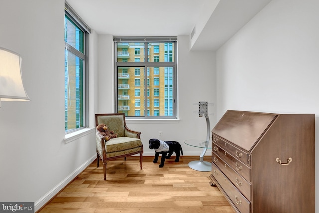 11990 Market St Unit 907, Reston, VA 20190 - sitting room featuring light wood-type flooring and baseboards
