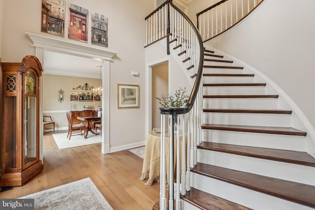 660 Casey Ln, West Chester, PA 19382 - stairs with wood-type flooring, a towering ceiling, and crown molding