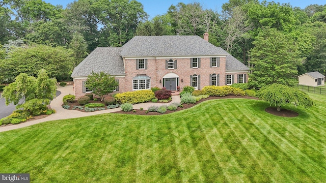 660 Casey Ln, West Chester, PA 19382 - colonial-style house with a front yard, brick siding, and a chimney