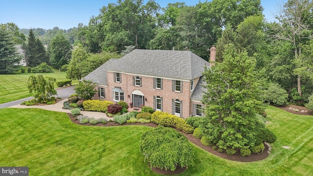 660 Casey Ln, West Chester, PA 19382 - colonial inspired home with a chimney, a front lawn, brick siding, and roof with shingles