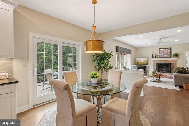 660 Casey Ln, West Chester, PA 19382 - dining room featuring light wood-type flooring, a brick fireplace, recessed lighting, and ceiling fan