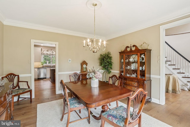 660 Casey Ln, West Chester, PA 19382 - dining area featuring wood finished floors, a chandelier, crown molding, and stairs