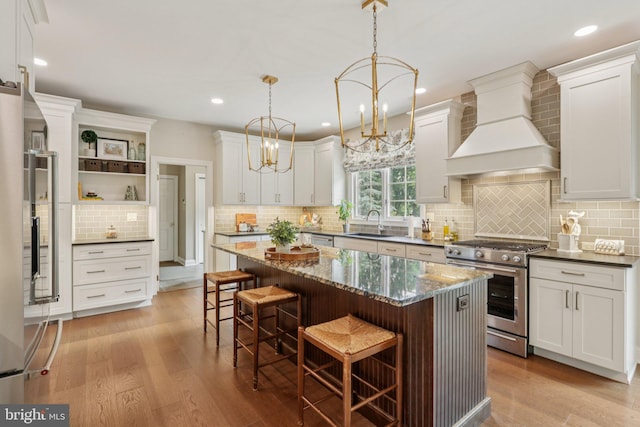660 Casey Ln, West Chester, PA 19382 - kitchen with appliances with stainless steel finishes, premium range hood, open shelves, tasteful backsplash, and a breakfast bar area