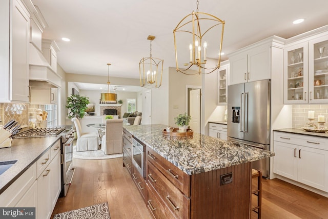 660 Casey Ln, West Chester, PA 19382 - kitchen featuring high end appliances, tasteful backsplash, recessed lighting, dark wood finished floors, and a breakfast bar area