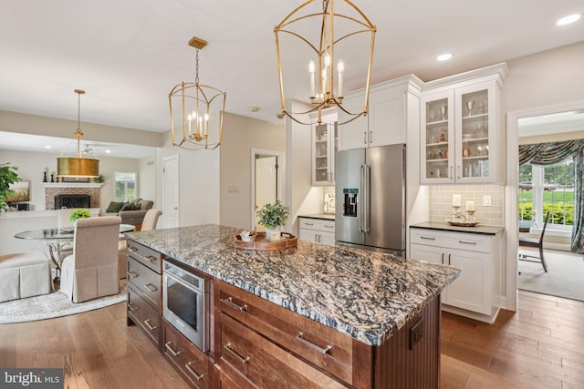 660 Casey Ln, West Chester, PA 19382 - kitchen with high end refrigerator, dark wood finished floors, a chandelier, glass insert cabinets, and white cabinetry
