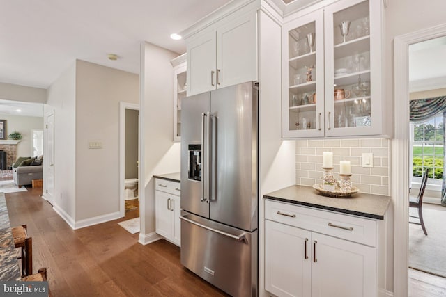 660 Casey Ln, West Chester, PA 19382 - kitchen with high end fridge, dark countertops, dark wood-style flooring, glass insert cabinets, and white cabinetry