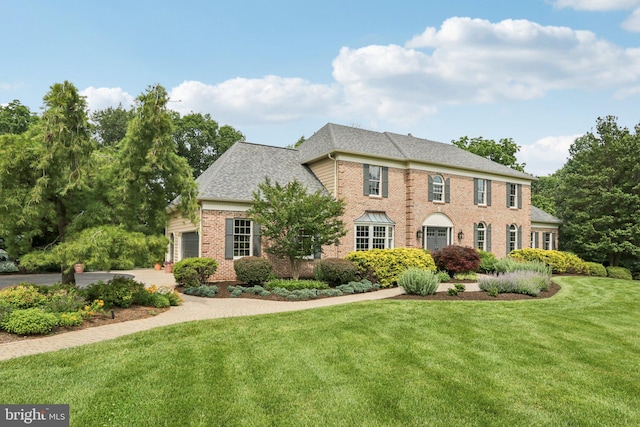 660 Casey Ln, West Chester, PA 19382 - colonial home with brick siding, a front lawn, a garage, a shingled roof, and driveway